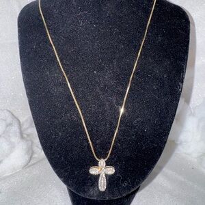 14k gold necklace with a 10k diamond cross including baguettes.